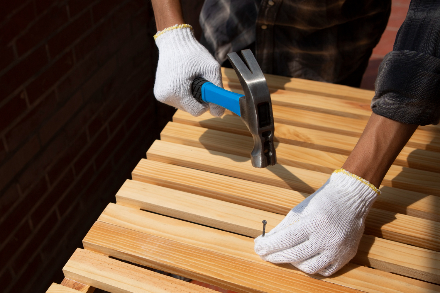 worker using hammer at job site